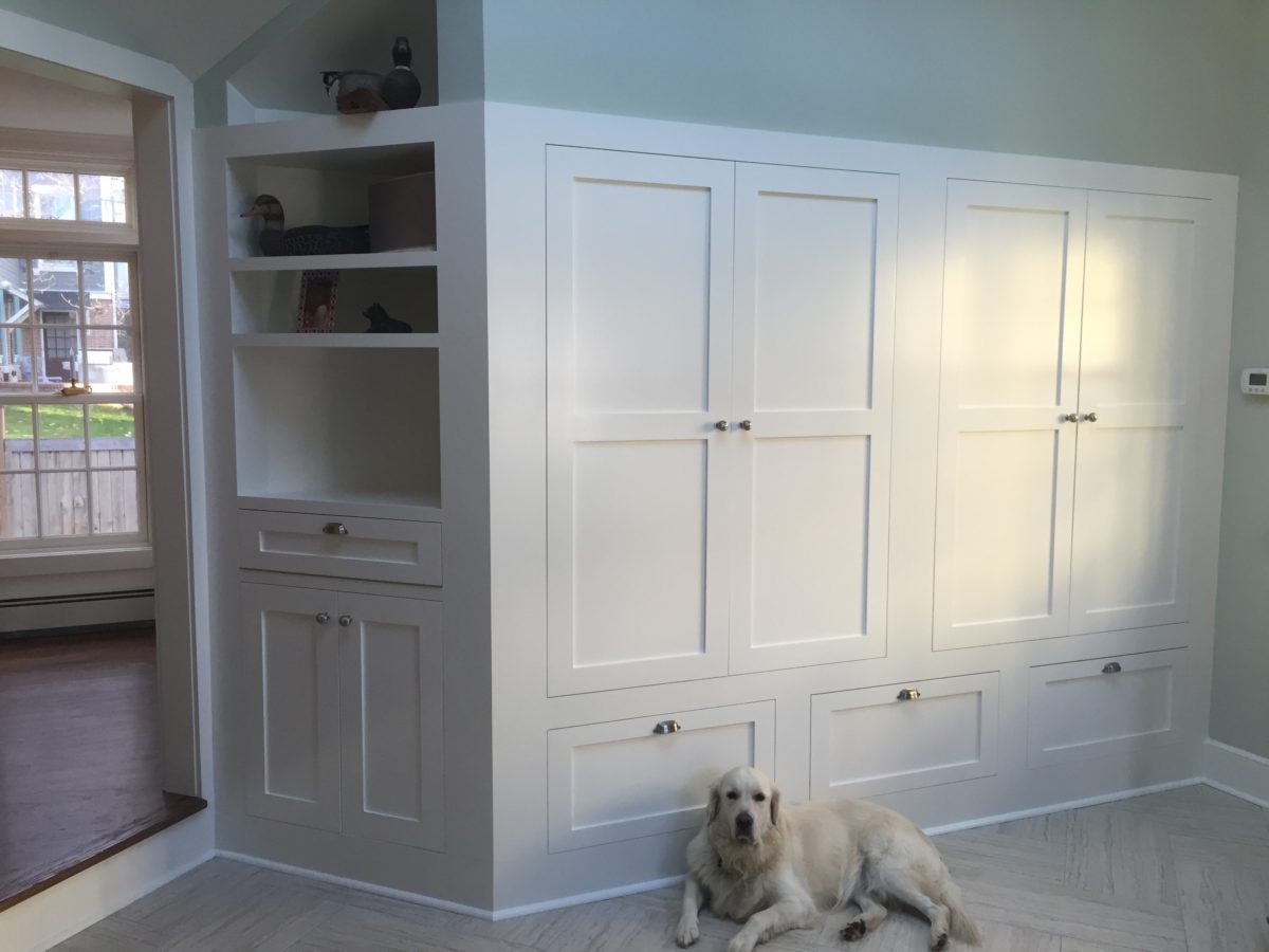 mudroom with white cabinets and chrome hardware