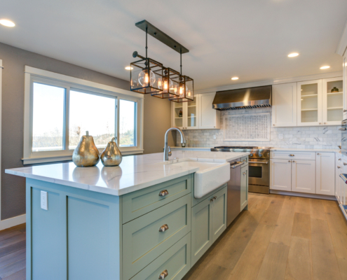 Beautiful kitchen room with green island and farm sink. kitchen remodel
